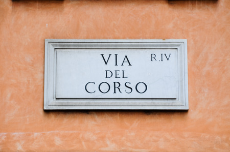 Road sign indicating a street name in Italian "Via del corso " in English means corso road, romeのeditorial素材