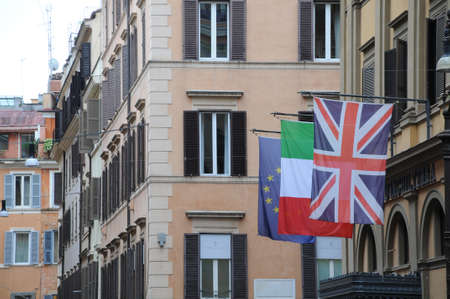 Rome street with flags of Italy, England and European Union,italyのeditorial素材