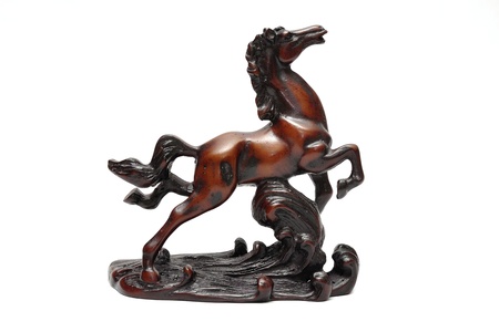 Beautiful sculpture of horse made of wood isolated on the white backgroundの写真素材