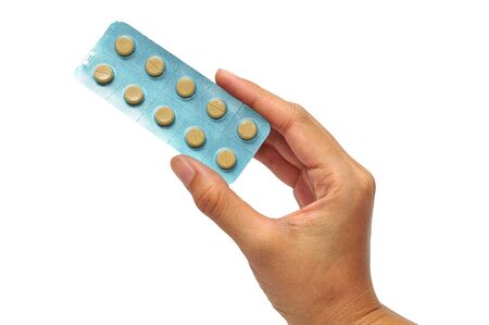 Medicine in a hand on white backgroundの写真素材