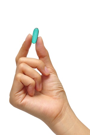 Medicine in a hand on white backgroundの写真素材