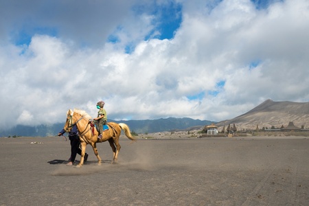 EAST JAVA,INDONESIA-MAY 05 : Tourists ride the horse at Mount Bromo, The active Mount Bromo is one of the most visited tourist attractions and part of the Tengger massif on May 05,2013 in East Java, Indonesia.のeditorial素材