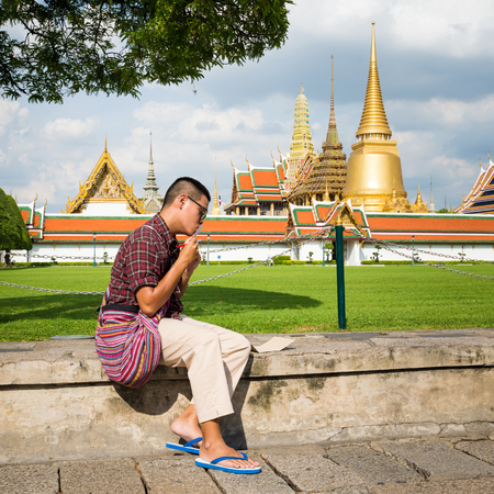 Asian boy enjoying at Wat Phra Kaew, Temple of the Emerald Buddha, Bangkok, Thailand.のeditorial素材