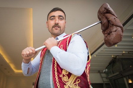 ISTANBULAPRIL 08: An ice cream seller dressed in traditional Turkish costume drums up customers. Istanbul is one of the most popular destinations in the world. On April 08 2015 in Istanbul Turkeyのeditorial素材