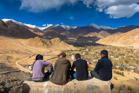 Unidentified Tibetan men siting at viewpoint of Leh city on May 6, 2014 in Leh Ladakh, Northern India. There are many Tibetan refugees living in Ladakh.のeditorial素材