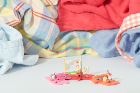 Miniature figure of woman doing laundry concept