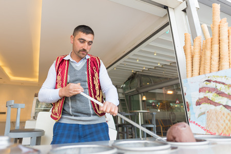 ISTANBULAPRIL 08: An ice cream seller dressed in traditional Turkish costume drums up customers. Istanbul is one of the most popular destinations in the world. On April 08 2015 in Istanbul Turkeyのeditorial素材