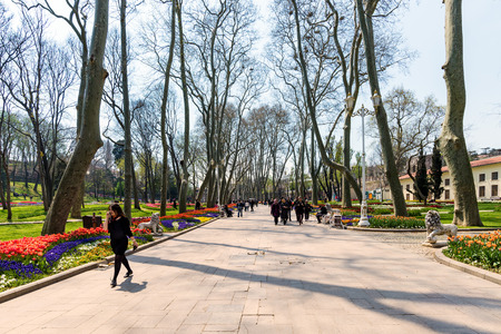 ISTANBUL,TURKEY - APRIL 08, 2015: Tourists in a garden near Sultanahmet square. The Sultanahmet square is the popular tourist place with the numerous landmarks and museums.のeditorial素材