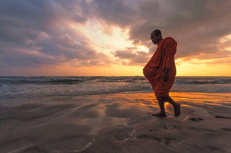 HUA-HIN, THAILAND - DEC 11: Unidentified Buddhist monks walk for people offering food in the early morning on December 11, 2011. Offering food is one of most common rituals in Buddhism.のeditorial素材