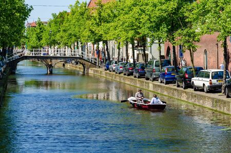 DELFT,THE NETHERLANDS - APRIL 16: Canal in Delft on April 16, 2014 in the city of Delft , the Netherlands. Delft is known for its historic town centre with canals and a popular touristic destination.のeditorial素材