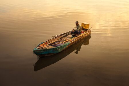 CHONBURI, THAILAND- MAY04, 2010 : Fisherman on his boat going to catch fish in the sea on May 04 Chonburi, Thailand.Chonburi is home to Thailand's largest tourist oriented city, Pattayaのeditorial素材