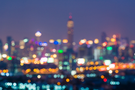 Blurred night downtown city, building background with light bokeh scene.blur backgrounds conceptの写真素材