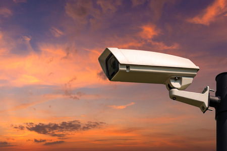 Single CCTV Security camera on beautiful sunrise sky and clouds background