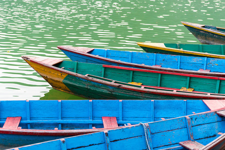 Colourful attraction Boats docked at the Phewa lake in Pokhara, Nepal. Selective focus at middle boatの写真素材