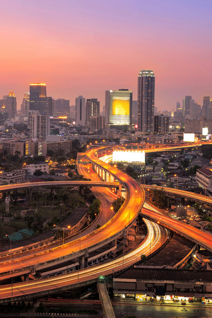 Modern office buildings, condominium in big city downtown with Motorway, Expressway, Freeway the infrastructure for transportation in modern city, urban view at twilight timeの写真素材