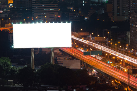 Blank billboard ready for new advertisement at expressway at night in downtown cityの写真素材