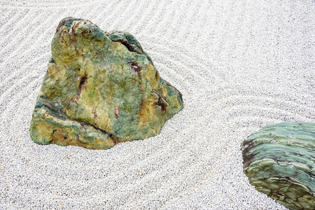 Japanese zen garden meditation stone in lines sand for relaxation balance and harmony spirituality or wellness in Kyoto,Japan.の写真素材