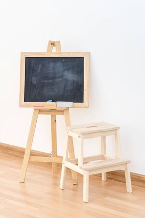Wooden blank blackboard inside the room for kids playing and education teaching by parent for modern...