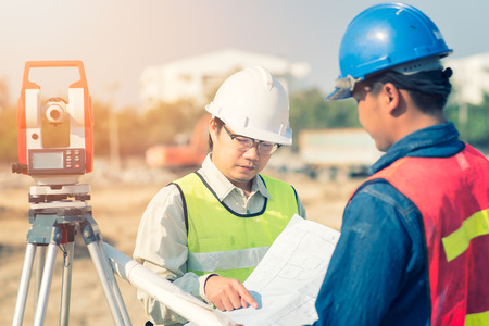 Construction engineer with foreman worker checking construction drawing for new Infrastructure project. photo concept for engineering work.の写真素材
