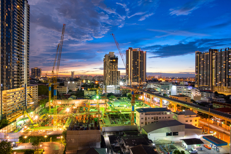 Construction site with backhoe and dump truck busy operate in beginning of building new complex building project in Thailand.の写真素材