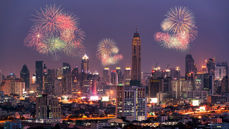 Fireworks light up show on sky over Bangkok City downtown at night,Thailand. Bangkok is the most populated city in Southeast Asia.の写真素材