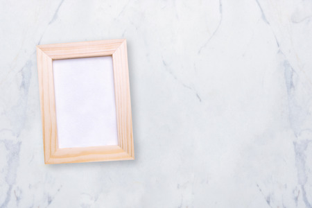Top view of nature wooden photo frame on marble table. Elegant Design with copy space for placement your text, mock up your product.の写真素材
