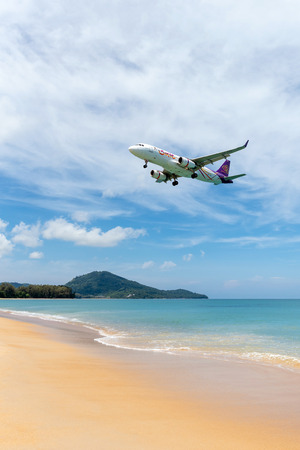 PHUKET,THAILAND-MAY05:Unidentified tourists at Mai Khao beach with commercial aircraft landing at Phuket International Airport on May 5,2108.のeditorial素材