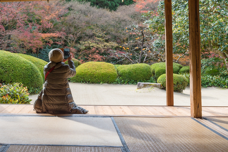 KYOTO, JAPAN - NOV 25 :Tourists enjoy watching maple leaf in zen garden at Japanese temple on...
