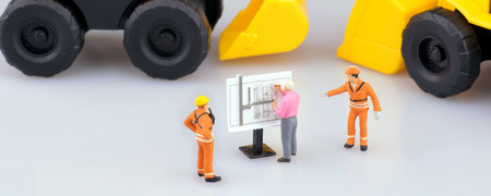 Miniature engineering people and architecture working on construction drawing in cover banner size. Elegant Design for industrial and construction concept.の写真素材