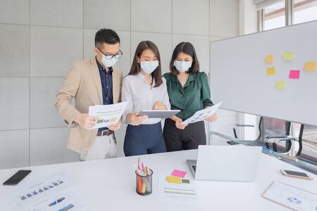 Business employees wearing mask during work in office to keep hygiene follow company policy.Preventive during the period of epidemic from coronavirus or covid19.の写真素材