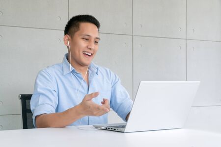Business man using laptop to video conferencing with colleagues via internet technology at home...