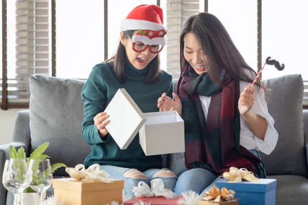 Two Females enjoy to celebrate Christmas and new year party at home in Decemberの写真素材