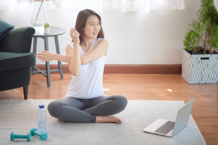 Beautiful asian woman staying fit by exercising at home for healthy trend lifestyleの写真素材