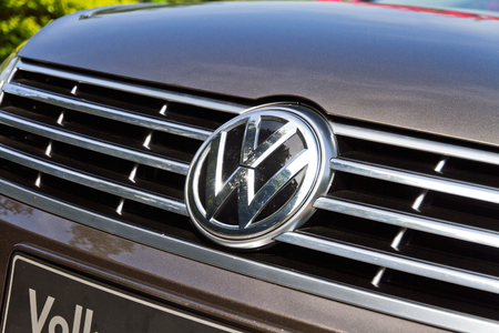 Wet Volkswagen metallic logo on a car hood. Volkswagen is a German, world famous, motor vehicles manufacturer brand which also owns the Audi, Bentley, Bugatti, Lamborghini, SEAT, and Å koda marques. The world Volkswagen means -people car- in German.のeditorial素材
