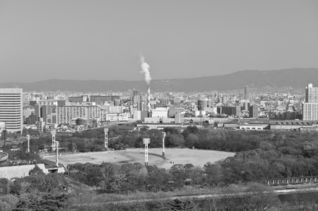 oil refinery with smoke stacks against. black and white photo.の写真素材