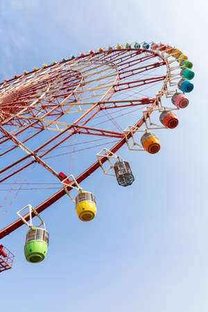 Odaiba colorful tall Palette Town Ferris wheel named Daikanransha visible from the central urban area of Tokyo in the summer blue sky.の写真素材