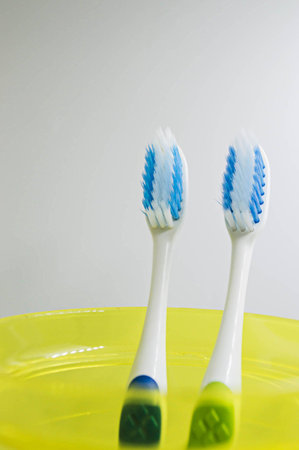 tooth brush and toothpaste in glass on white background.の写真素材