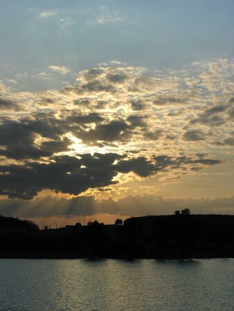 dusk in sky above the lake waterの写真素材
