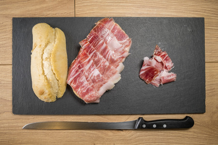 Iberian ham sandwich © rico de bellota with carving knifeの写真素材