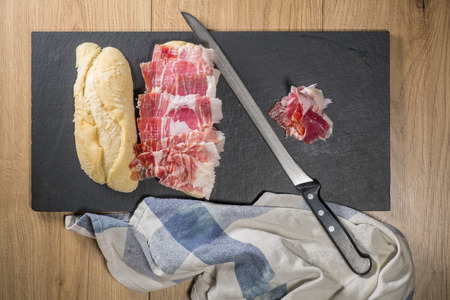 Iberian ham sandwich © rico de bellota and carving knifeの写真素材