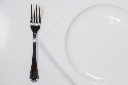 Fork and white dishの写真素材