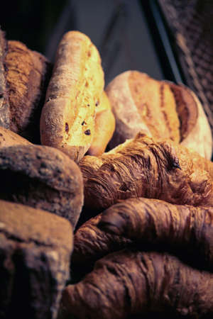 variety of croissants and breads in a bakery fresh from the ovenの写真素材