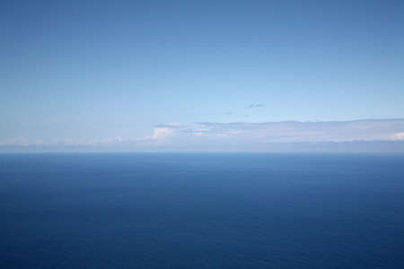 Aerial ocean landscape with blue sky and clouds on the horizonの写真素材