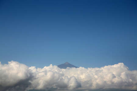 Teide volcano above the clouds, aerial photo, blue sky and sea of clouds.の写真素材