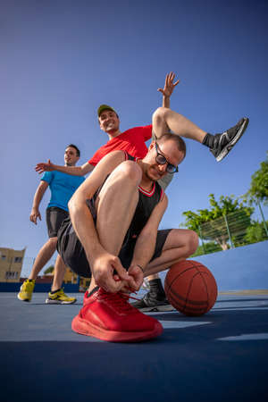 Friends, boys having fun laughing and playing basketball.の写真素材