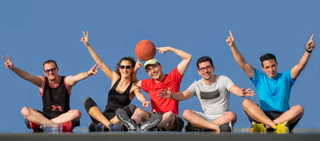 Friends, boys and girl having fun laughing and playing basketball.の写真素材