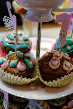 Beautiful cake plate/stand full of colorful and tasty homemade muffins for a one year old child birthday partyの写真素材
