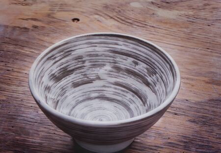 Oriental style lunch preparattion: empty vintage japanese bowl on a rustic wooden boardの写真素材