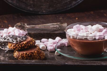 Home made hot chocolate, served on a vintage metal tray with chocolate cookies and marshmallowsの写真素材