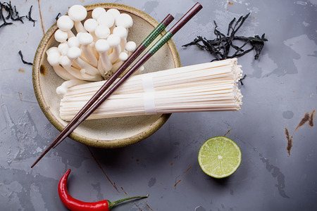 Ingredients for Japanese udon noodle soup. Noodles, bok choi cabbage, enoki and shimeji mushrooms,...